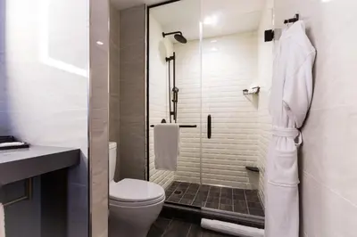 a bathroom with a toilet and a glass shower at Crowne Plaza HY36 Midtown Manhattan by IHG in New York
