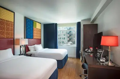 a hotel room with two beds and a window at Hotel Hayden New York in New York