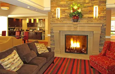 a living room with a fireplace and a couch at Penn Wells Lodge in Wellsboro