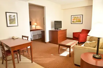 a living room with a room with a couch and a tv at Penn Wells Lodge in Wellsboro