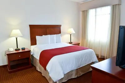 a hotel room with a bed and a television at Penn Wells Lodge in Wellsboro