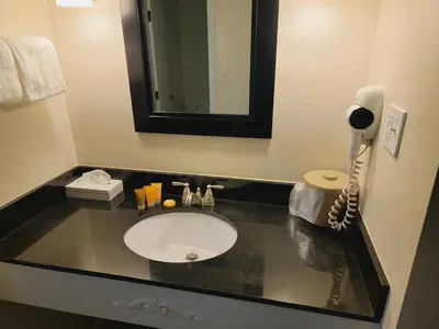 a bathroom with a sink and a phone on a counter at Penn Wells Lodge in Wellsboro