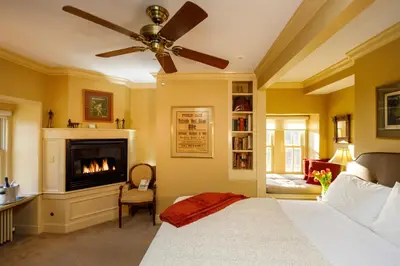 a bedroom with a bed and a fireplace at Woolverton Inn in Stockton