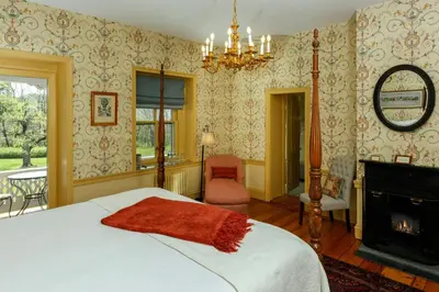 a bedroom with a bed and a fireplace at Woolverton Inn in Stockton