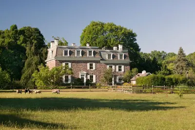 a large house with two animals in a field at Woolverton Inn in Stockton