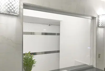 a sliding glass door in a bathroom with a plant at Ramsey Inn & Suites in Ramsey