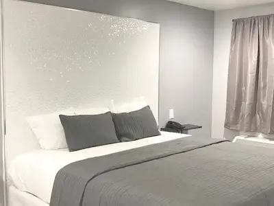 a bedroom with a large bed and a window at Ramsey Inn & Suites in Ramsey