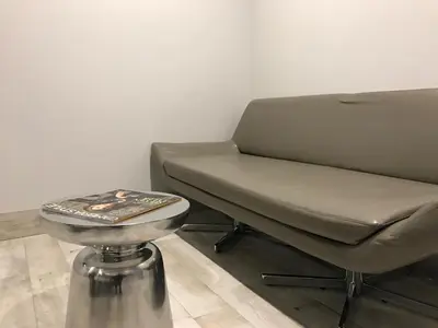 a bed and a stool in a room at Ramsey Inn & Suites in Ramsey