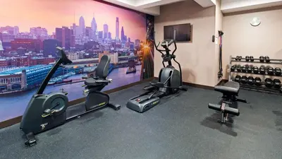 a gym with treadmills and exercise bikes in a room at Best Western Plus Philadelphia Convention Center Hotel in Philadelphia