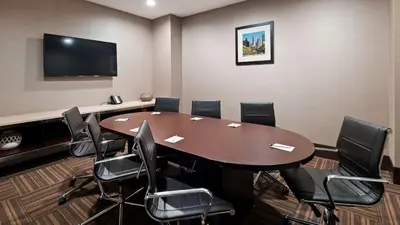 a conference room with a wooden table and chairs at Best Western Plus Philadelphia Convention Center Hotel in Philadelphia