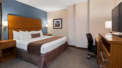 a hotel room with a large bed and a desk at Best Western Plus Philadelphia Convention Center Hotel in Philadelphia