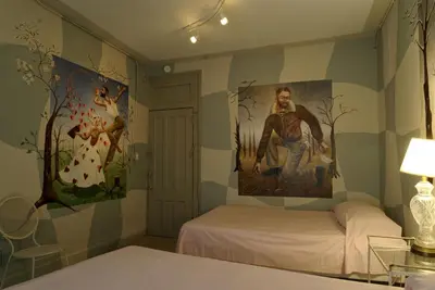a room with two beds and a painting on the wall at Carlton Arms Hotel in New York