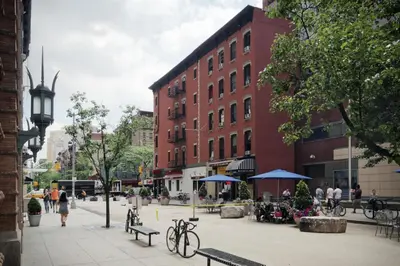 a city street with buildings and people walking on the sidewalk at Carlton Arms Hotel in New York