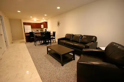 a living room with leather couches and a dining room at The Village at Pocono in Blakeslee