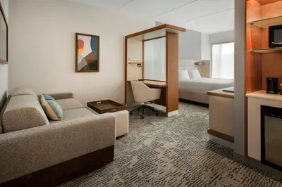 a hotel room with a couch and a bed at SpringHill Suites by Marriott Mount Laurel in Mount Laurel
