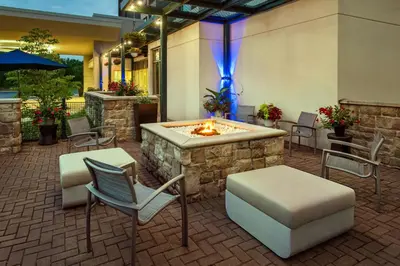a hotel patio with a fire pit and chairs at SpringHill Suites by Marriott Mount Laurel in Mount Laurel