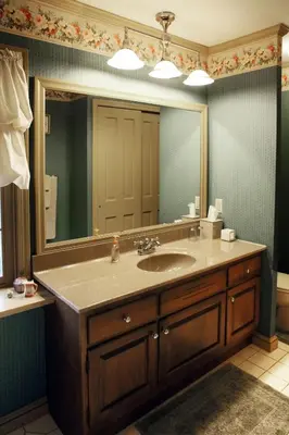 a bathroom with a sink and a large mirror at Apple Bin Inn in Willow Street