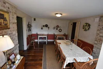 a dining room with a table and a table and chairs at Apple Bin Inn in Willow Street