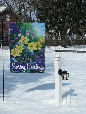 a sign in the snow with flowers on it at Apple Bin Inn in Willow Street