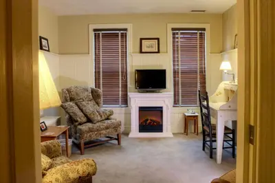a living room with a fireplace and a tv at Apple Bin Inn in Willow Street