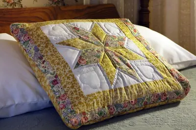 a quilt hooked up to a pillow on a bed at Apple Bin Inn in Willow Street