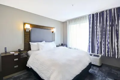 a hotel room with a bed and a window at TownePlace Suites by Marriott Cranbury South Brunswick in Cranbury