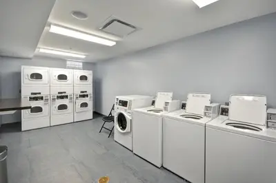a laundry room with white washers and dryers at TownePlace Suites by Marriott Cranbury South Brunswick in Cranbury