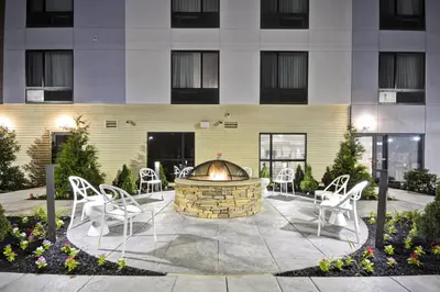 a fire pit in a courtyard in front of a building at TownePlace Suites by Marriott Cranbury South Brunswick in Cranbury