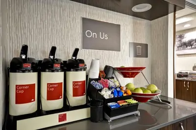 a group of wine bottles on a counter with a bowl of fruit at TownePlace Suites by Marriott Cranbury South Brunswick in Cranbury