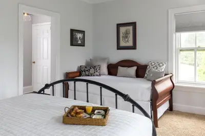 a bedroom with two beds and a basket of food at Pheasant Field Bed and Breakfast in Carlisle