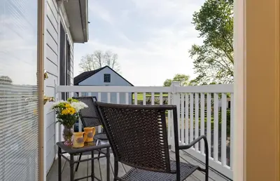 a balcony with two chairs and a table at Pheasant Field Bed and Breakfast in Carlisle