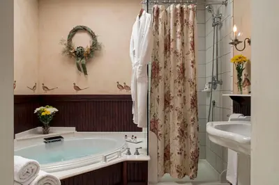 a bathroom with a tub and a sink at Pheasant Field Bed and Breakfast in Carlisle