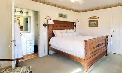 a bedroom with a large bed and a sink at Pheasant Field Bed and Breakfast in Carlisle