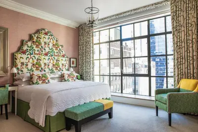 a bedroom with a large bed and a large window at The Whitby Hotel in New York