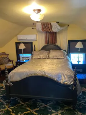 a bedroom with a large bed with a canopy at Hillcrest Bed and Breakfast in Jim Thorpe