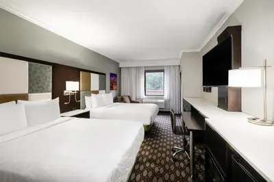 a hotel room with two beds and a flat screen tv at Best Western Premier NYC Gateway Hotel in North Bergen