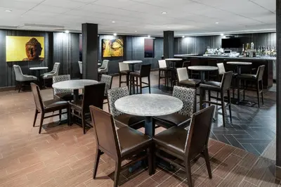 a restaurant with tables and chairs and a bar at Best Western Premier NYC Gateway Hotel in North Bergen