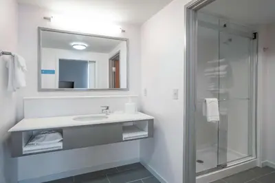 a bathroom with a sink and a shower at Hampton Inn & Suites Newburgh Stewart Airport, NY in Newburgh