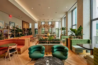 a lobby with green chairs and tables at Park Terrace Hotel in New York