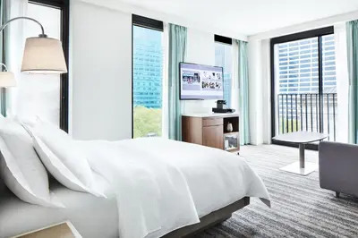 a bedroom with a white bed and large windows at Park Terrace Hotel in New York