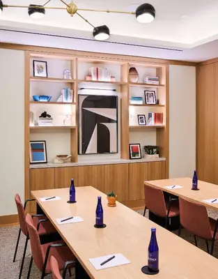a conference room with two tables and a large mirror at Park Terrace Hotel in New York