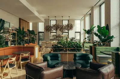 a lobby with plants and tables and chairs at Park Terrace Hotel in New York