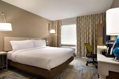 a hotel room with a bed and a desk and a computer at Hilton Garden Inn New York Times Square South in New York