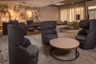 a waiting room with chairs and a table at Courtyard by Marriott Hershey Chocolate Avenue in Hershey