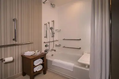 a bathroom with a bath tub and a shower at Courtyard by Marriott Hershey Chocolate Avenue in Hershey