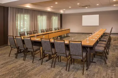 a large conference room with a long table and chairs at Courtyard by Marriott Hershey Chocolate Avenue in Hershey
