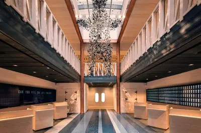 a hallway with chairs and a chandelier in a building at Moxy NYC Times Square in New York