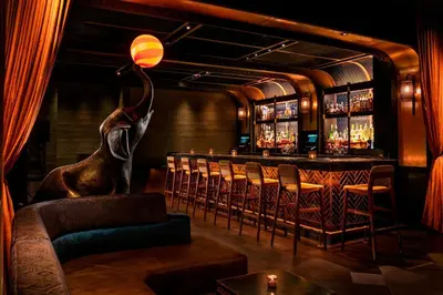 a bar with an elephant statue in a room at Moxy NYC Times Square in New York