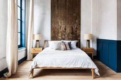 a bedroom with a bed with a wooden headboard at Lokal Hotel Old City in Philadelphia