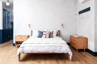 a bedroom with a bed and a wooden nightstand at Lokal Hotel Old City in Philadelphia